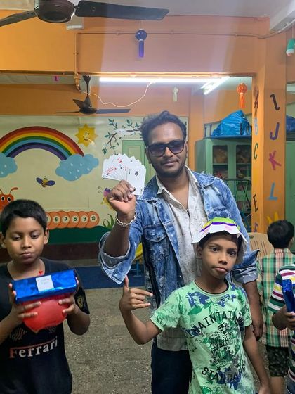 The best part of close-up magic is seeing the reactions up close. Here, I am surrounded by children at a school event, ready to be amazed by a card trick.