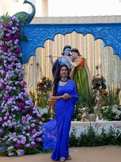 Posing against a beautiful, traditional backdrop at a daytime event. The decor was as vibrant as the celebration itself.
