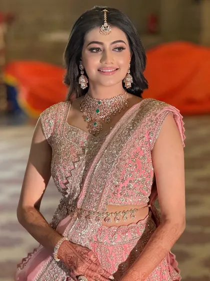 A smiling portrait of the bride, looking happy and confident in her glamorous reception attire.
