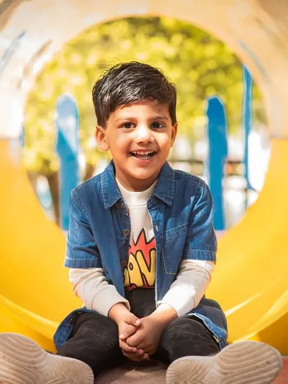 Let kids be kids. My goal during children's photoshoots is to capture their natural personality, and this bright, happy portrait of a boy on a playground slide does just that.