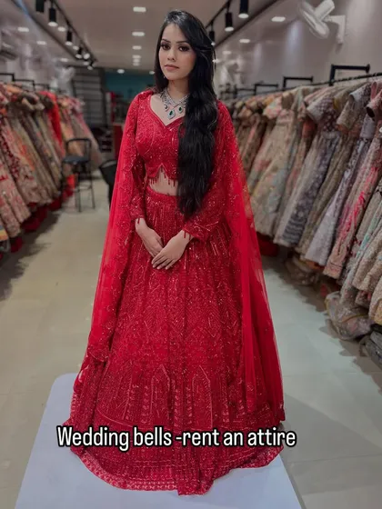 A full look at this fiery red lehenga with cape-style sleeves. It's a modern, powerful, and glamorous outfit available for you to rent and rock.