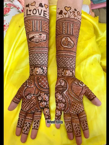 An engagement mehendi design with the word 'LOVE' and engagement rings. It's a sweet and romantic way to celebrate the occasion.