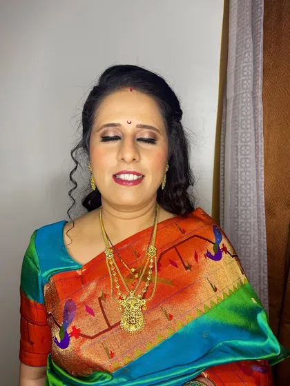 A close-up of Mrinal's reception makeup. I used warm, shimmery tones on her eyes and a classic red lip to create a timelessly beautiful look.