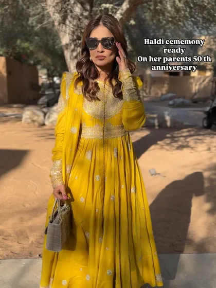 Another shot of the Haldi look. The sunglasses add a touch of modern chic to the traditional outfit.