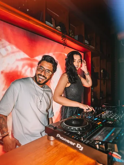 A close-up of us at the Pioneer DJ console. We both love what we do, and it shows in every performance.