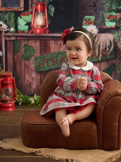 A happy moment at the strawberry patch. We capture your baby's natural smiles and expressions as they enjoy our themed environments.