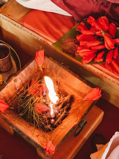 A close-up of a Homa, or fire ceremony. The offering of herbs and flowers into the sacred fire symbolizes the release of ego and the cultivation of devotion.