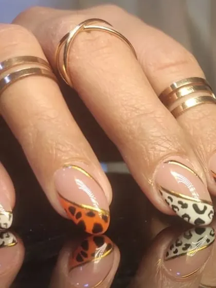 A side view of the stylish leopard print French tip design.