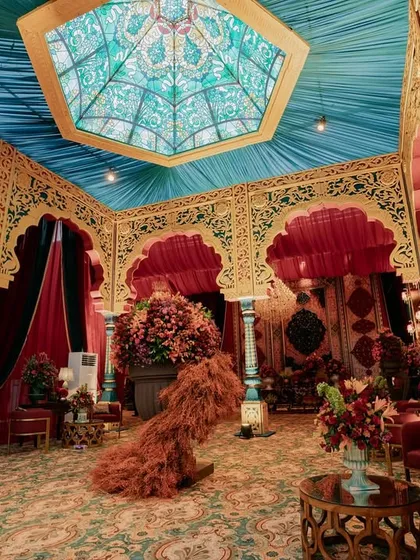 A view inside our recreation of the Mysore Palace's Durbar Hall. The hand-crafted hexagonal ceiling with stained glass motifs, turquoise pillars, and gilded arches were all meticulously designed to transport guests into a world of Indo-Saracenic royal splendor.