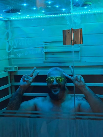 A client flashes a peace sign while enjoying his session. The goal at Salt World is to provide an experience that is not only beneficial for your body but also genuinely enjoyable and uplifting.