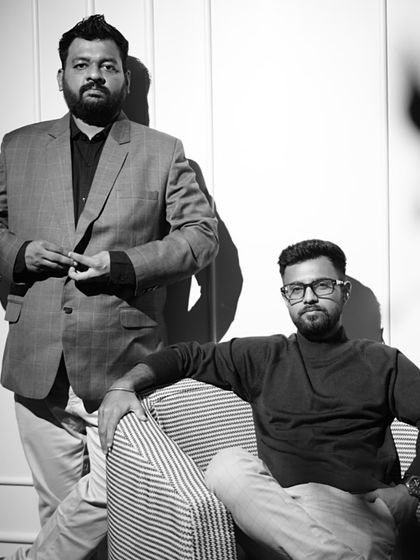 A black and white portrait of us, the founders of Nirmaan Architects. Our design philosophy is built on a decade of experience, a client-centric approach, and a passion for timeless design.