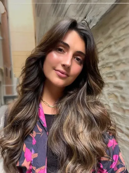 Soft, sun-kissed highlights on long, wavy hair. This look is part of our Autumn Shades collection, perfect for adding warmth and dimension as the seasons change.