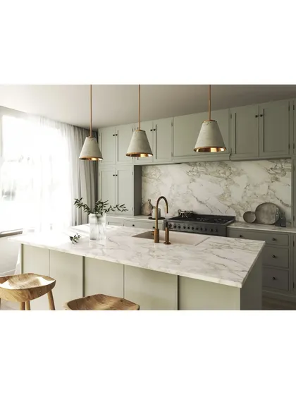 A closer look at a custom kitchen island with a stunning marble countertop. We designed this space with sage green shaker-style cabinets and elegant pendant lighting, blending classic and modern aesthetics for a timeless look.