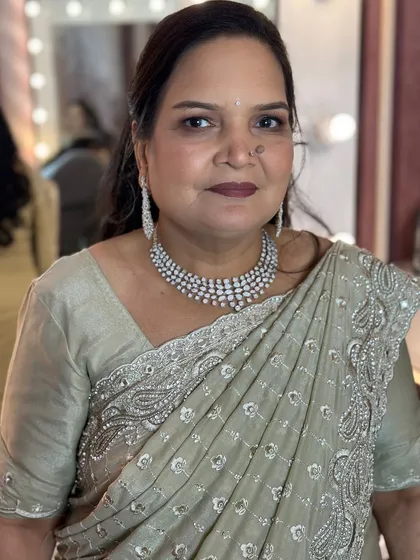 A beautiful and elegant makeover for a family member, with soft makeup and a classic saree.