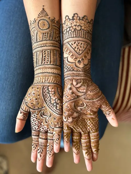 This is a beautiful example of a detailed bridal mehendi. One hand features a traditional mandala, while the other has a paisley design, showing how we can mix and match styles.