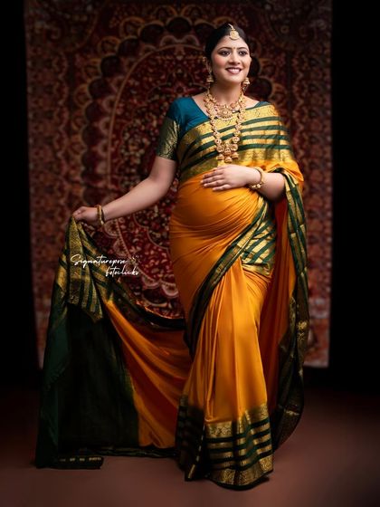 The rich colors of the yellow and green saree stand out in this elegant solo portrait.