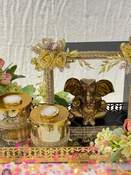 A truly divine Diwali gift. This hamper features a serene Ganesha idol in a decorative frame, paired with elegant agate-lidded jars on a golden tray, blending spirituality with luxurious design.