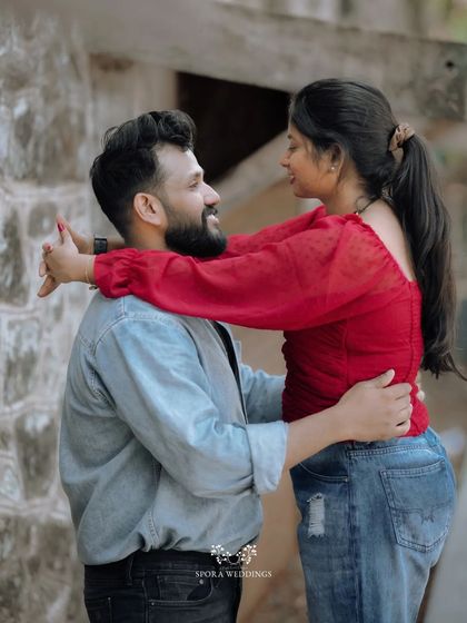 The couple looking into each other's eyes, their hands clasped, in a moment of loving connection.