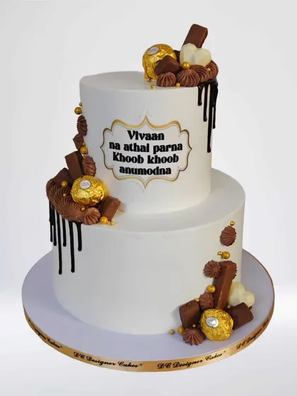 A special celebration cake for a young boy who completed an 8-day fast as per Jain traditions. The cake has a congratulatory message in Gujarati, "Khoob khoob anumodna," to honor his achievement.