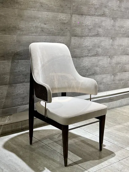 A contemporary dining chair with a classic touch. The off-white upholstery contrasts beautifully with the dark wood frame, making it a versatile choice for modern dining rooms.
