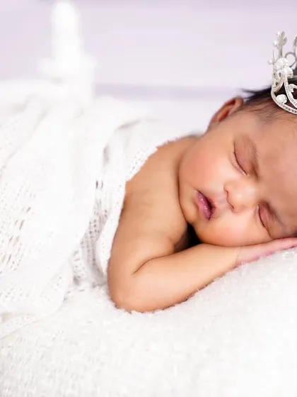 A tiny princess fast asleep, wearing a delicate crown. This simple prop adds a touch of magic to a classic newborn portrait.