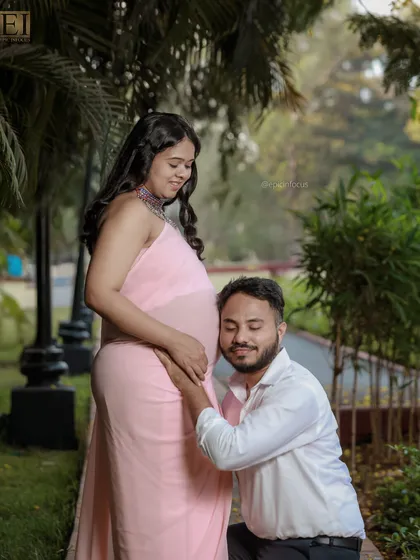 The dad-to-be lovingly listens to the baby bump. This is a classic and heartwarming pose we often capture in our couple sessions.
