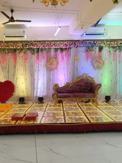 A beautiful stage setup for an engagement ceremony at our Badlapur hall. The elegant divan, floral backdrop, and illuminated LED dance floor create a perfect setting for your special moments. This is a popular choice for a small wedding reception venue.