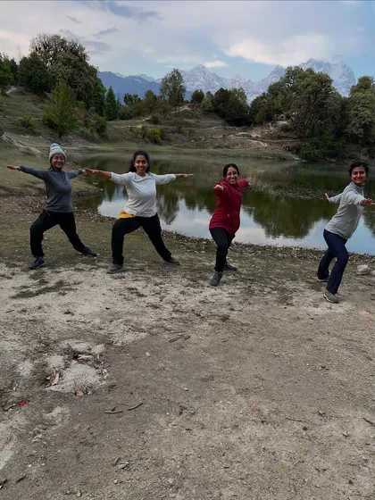 Sharing a moment of Virabhadrasana II, or Warrior II, with a wonderful group of women by a serene mountain lake. Group practice in nature fosters a powerful sense of community and shared strength. We support each other in finding our stability and focus.