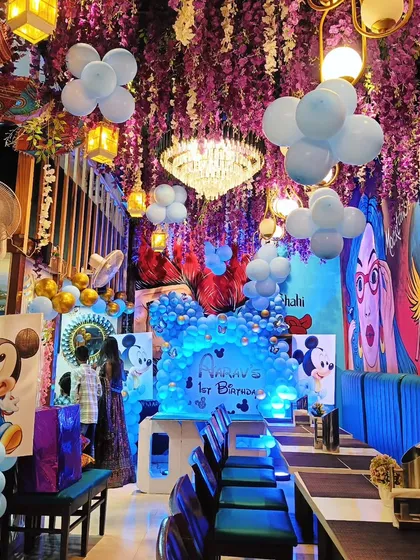 A full restaurant decorated for a Mickey Mouse themed birthday party. I can transform an entire venue with ceiling decorations, character cutouts, and themed balloon arrangements.