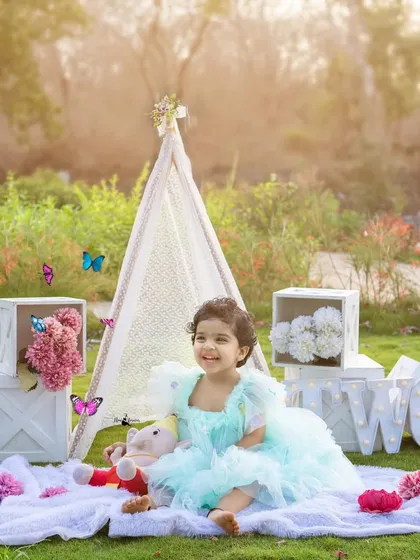 Celebrating a second birthday with a dreamy boho-picnic theme. Our outdoor setups, complete with a lace teepee and light-up letters, create a magical atmosphere for your toddler's milestone shoot.