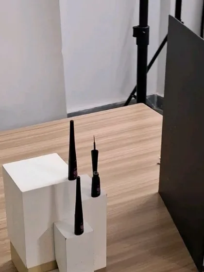A simple, clean setup for an eyeliner product shoot, using white blocks to create a minimalist composition.