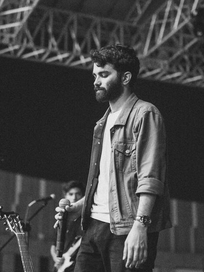 A monochrome shot capturing a quiet, emotional moment during a live performance. Whether it's a high-energy song or a soft ballad, I always sing from the heart.