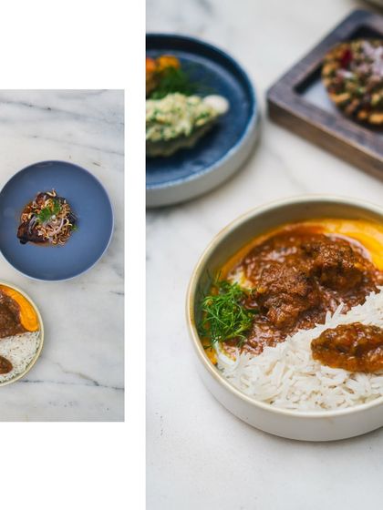 An overhead view of the diverse dishes offered in my flying buffet, including a hearty bowl of rice with curry and smaller plates with modern Indian creations.