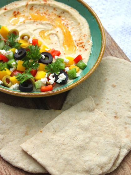 Our Lebanese Bowl is a vibrant and joyful dish. Dive into creamy hummus, fresh bell peppers, and zesty jalapeños, all served with warm, soft pita bread.