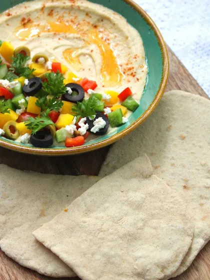 Our Lebanese Bowl is a vibrant and joyful dish. Dive into creamy hummus, fresh bell peppers, and zesty jalapeños, all served with warm, soft pita bread.