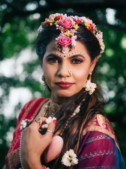 A close-up portrait from our Radha-themed shoot, focusing on the expressive eyes, floral crown, and traditional makeup that tell a story of divine love.