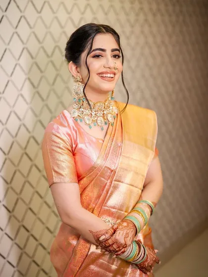 My bride Abha looked absolutely radiant for her Pheras. Her peachy-pink saree and mint green jewelry were so fresh and unique. I created a minimal glam look with a natural, glowy base to enhance her beauty without overpowering her style.