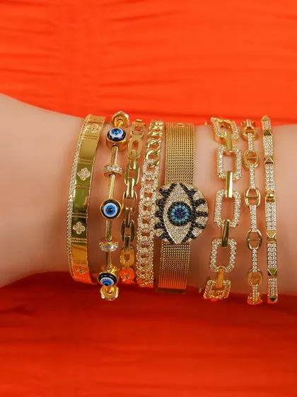 Getting your arm party summer-ready. This stack features some of my favorite evil eye and link chain bangles, perfect for adding a pop of color and protection to your look.