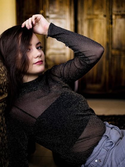 Another shot from the home portrait session, with the model looking at the camera with a gentle smile.