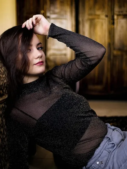 Another shot from the home portrait session, with the model looking at the camera with a gentle smile.