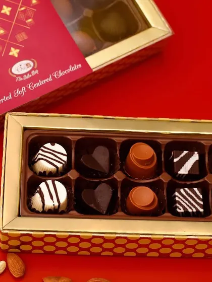 Our assorted soft-centered chocolates in a festive Diwali gift box, offering a variety of flavors like hazelnut, caramel, and coffee.