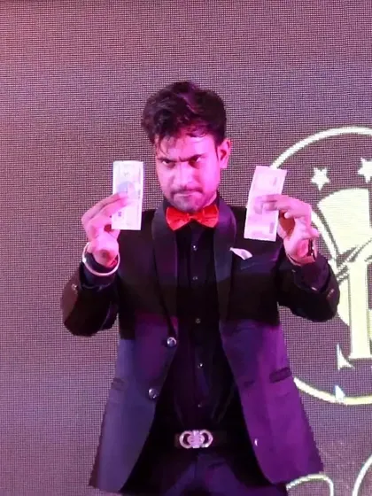 Performing a money multiplication trick on stage. Illusions involving money always capture the audience's imagination.