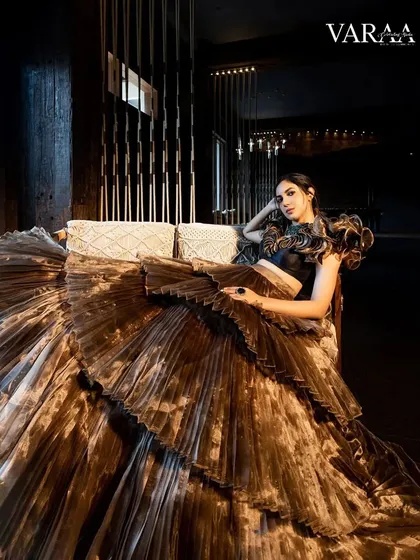 A moment of pure drama from our Varaa Magazine shoot with Ritu Varma. This stunning gold and black pleated lehenga by Sayaanika has incredible volume and texture. We styled it with a structured, ruffled top to create a powerful, high-fashion silhouette.
