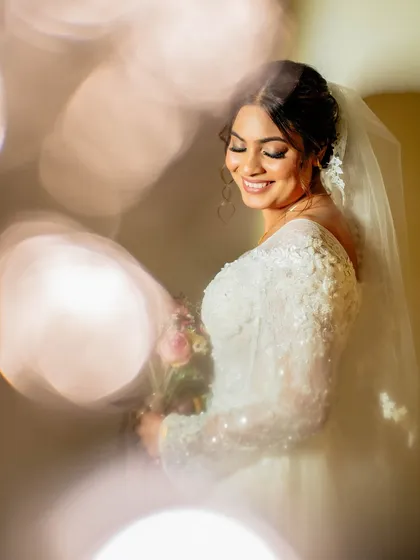 Another gorgeous shot with bokeh lights, highlighting the bride's serene expression.