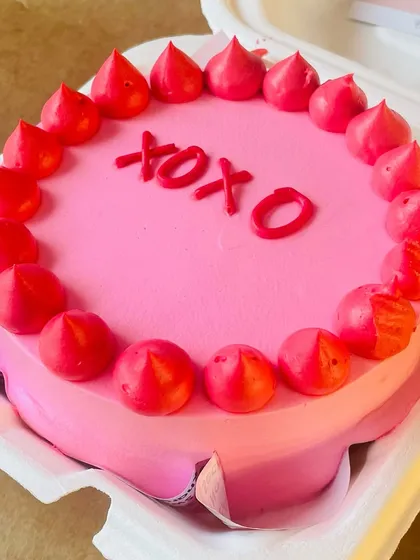 A Valentine's themed "XOXO" bento cake. Its small size makes it a perfect romantic treat for two.