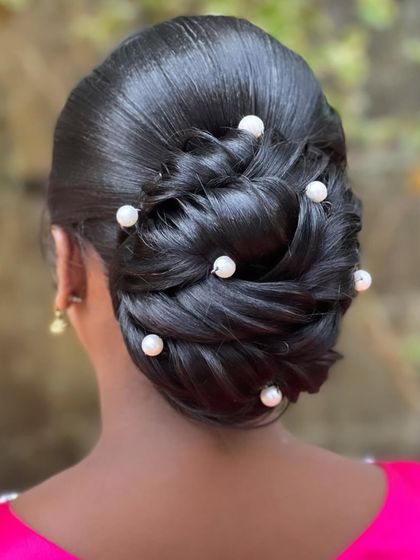 The final result of the pearl-adorned braided bun from my Sri Lanka masterclass, showing the intricate weaving and placement of accessories.