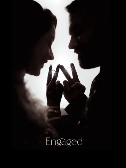 An engagement is the promise of forever, and I love creating artistic shots to celebrate it. This silhouette photo uses creative lighting to focus on the couple's connection and their newly exchanged rings, telling a powerful story in a simple, elegant frame.