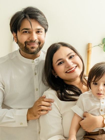 A classic family portrait in our warm, boho-themed studio. Everyone is looking at the camera, creating a timeless keepsake.