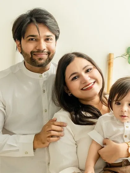 A classic family portrait in our warm, boho-themed studio. Everyone is looking at the camera, creating a timeless keepsake.