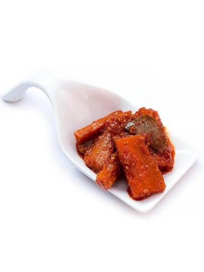 A clean, simple serving of our Carrot Chilli Pickle. This North Indian style pickle is a versatile condiment that pairs well with parathas, rice, and more.